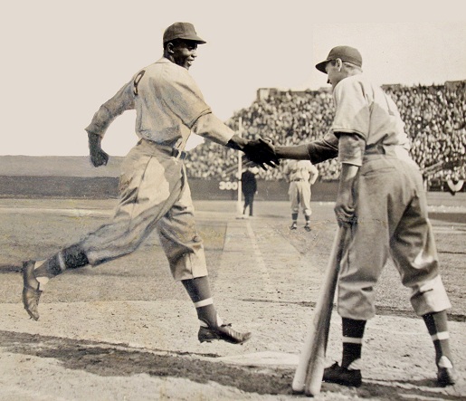 george-shuba-and-jackie-robinson-shake-hands-shot-from-behind-plate.jpg